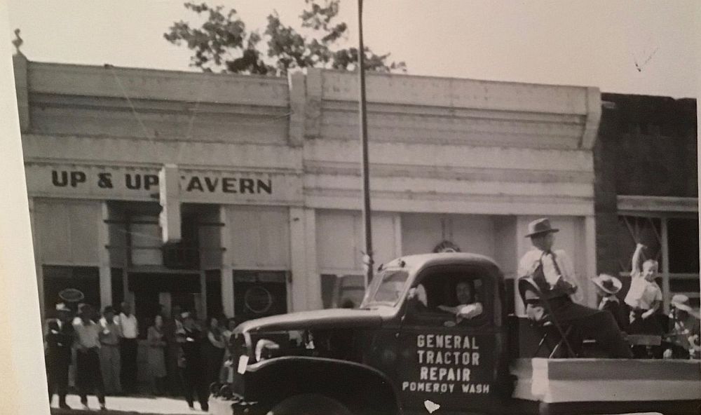 photo of a young Bill Stanley in the bed of a General Tractor Repair pickup in front of the Up & Up Tavern, Pomeroy WA, sometime in the early 50's